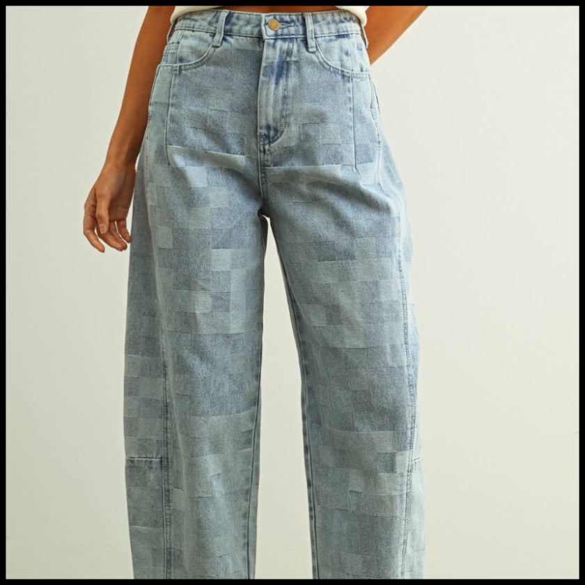 Person wearing light blue checkered jeans with a white background