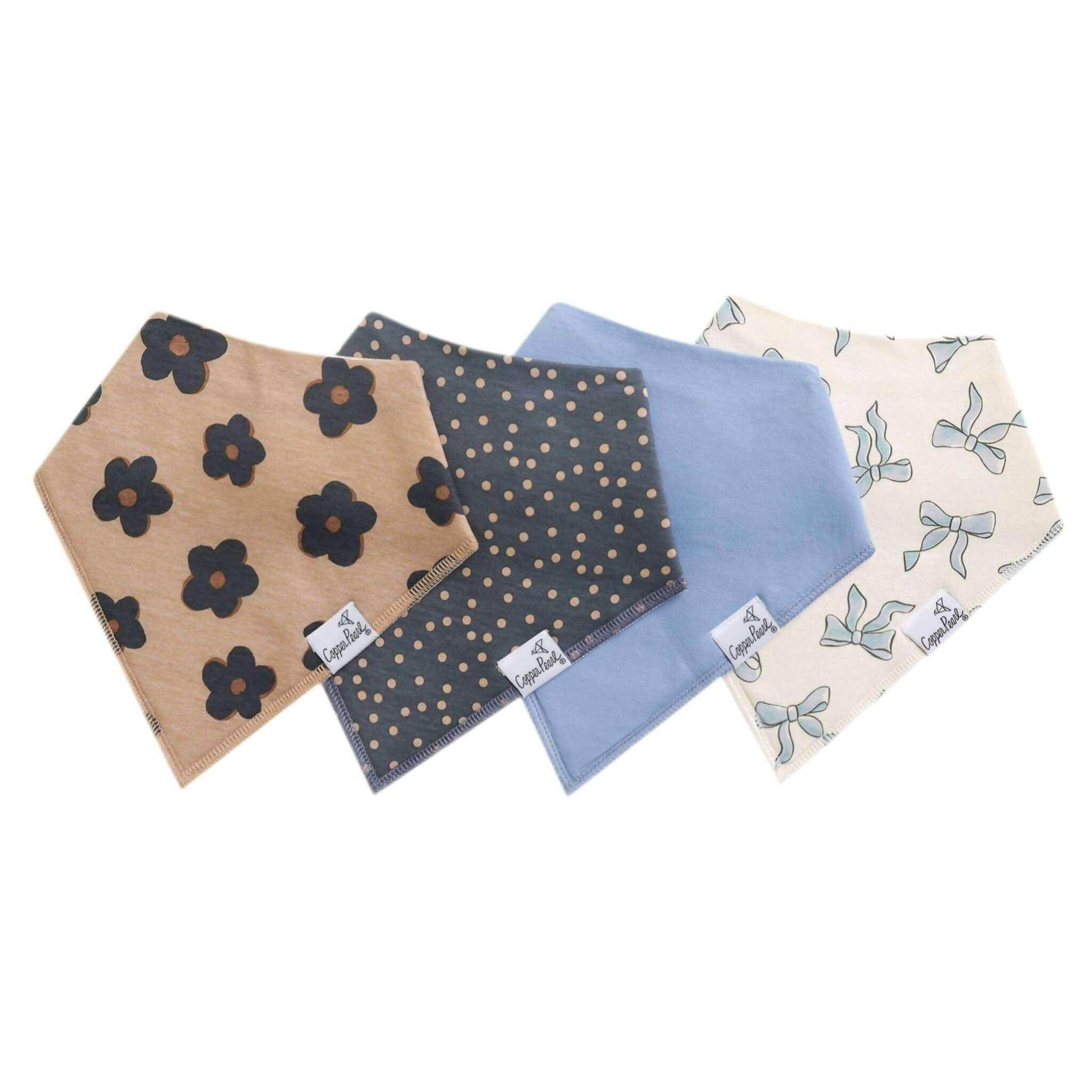 Four baby bibs with different patterns on a white background