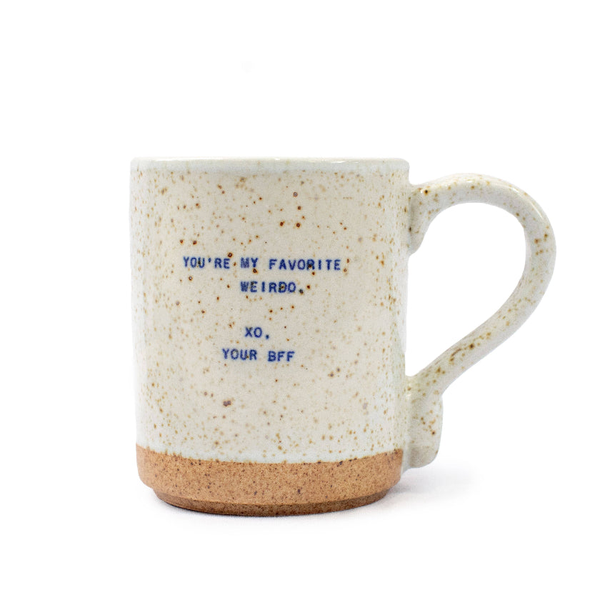 Speckled mug with text on a white background
