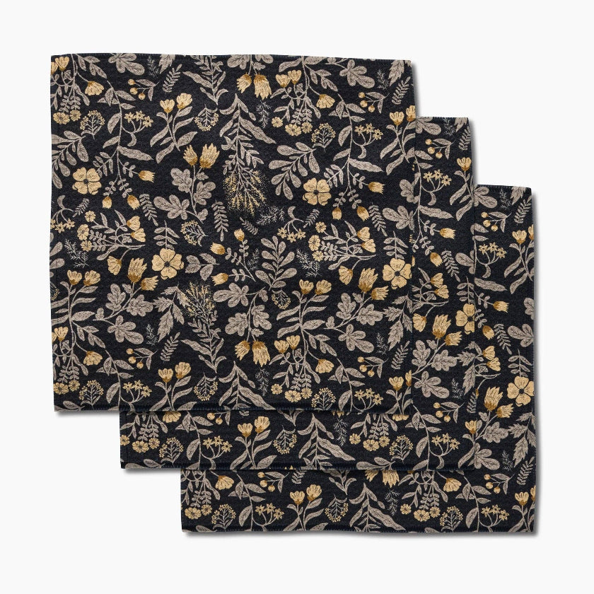 Set of three floral-patterned napkins on a white background