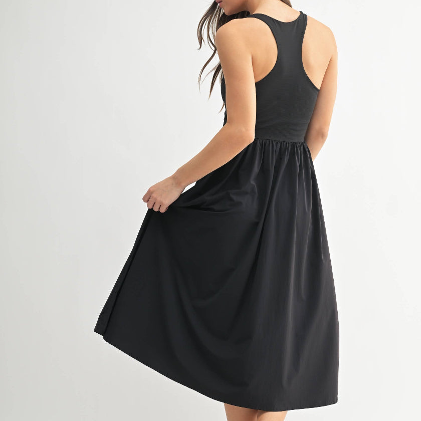 Woman wearing a black sleeveless dress on a white background
