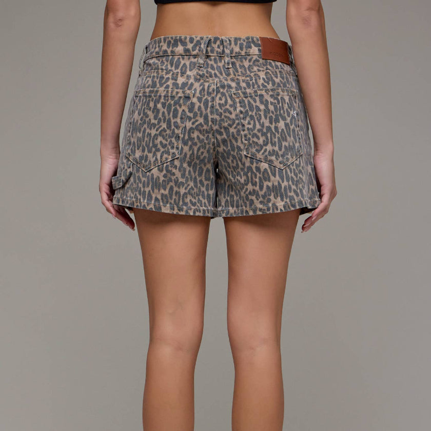 Animal print shorts worn by a person on a plain background
