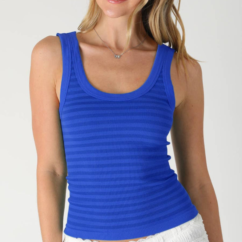 Woman wearing a blue tank top against a white background