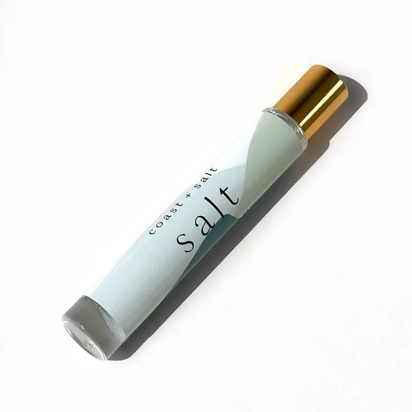 Roll-on bottle labeled 'salt' with a gold cap on a white background