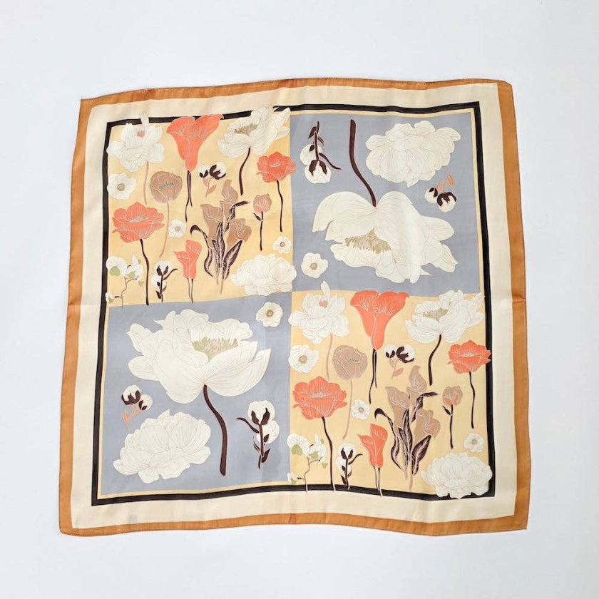 Floral patterned scarf with a beige border on a white background