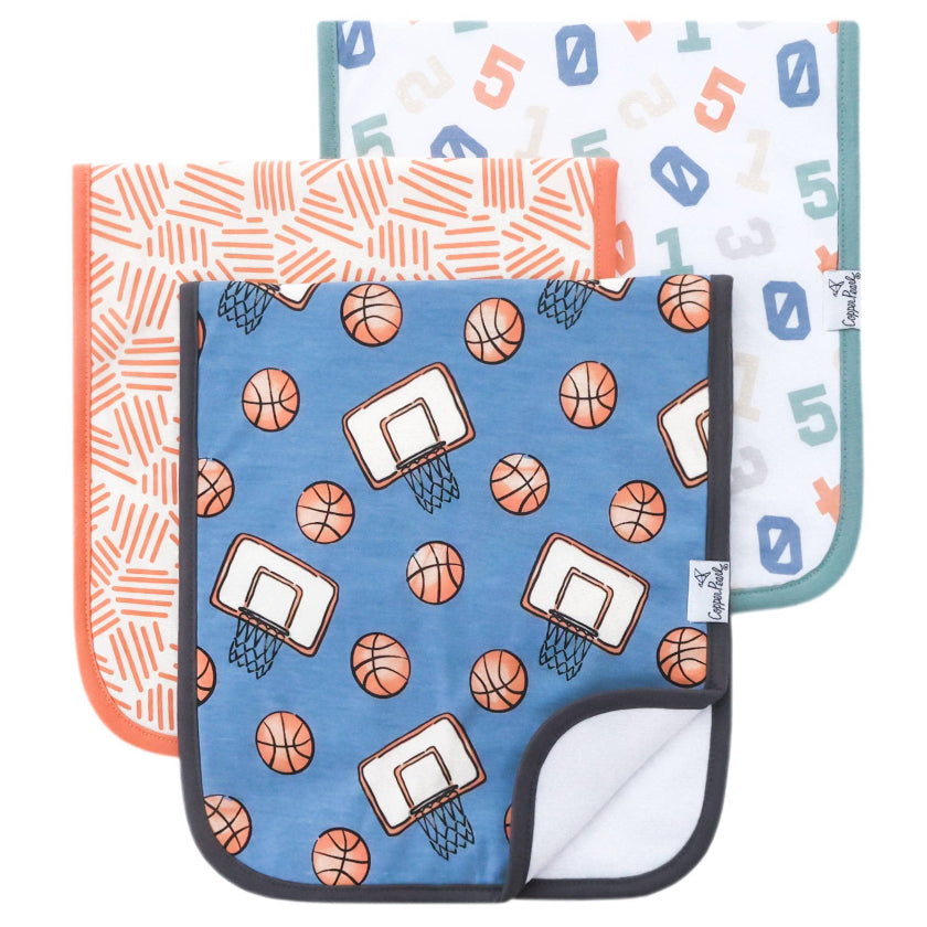 Three baby burp cloths with different patterns on a white background