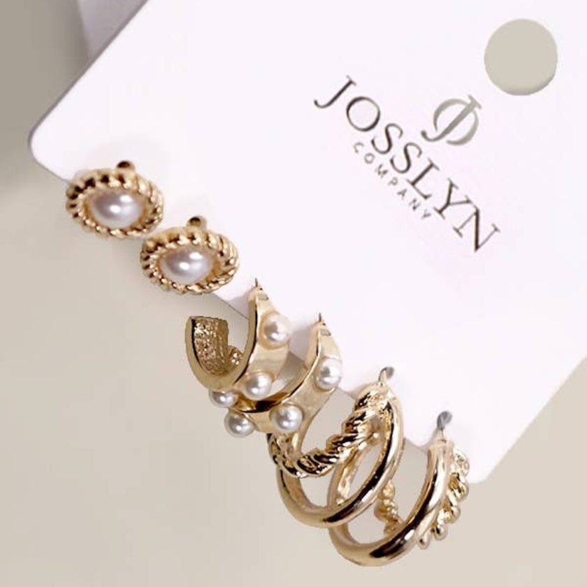 Set of gold and pearl earrings on a JOSSLYN branded card