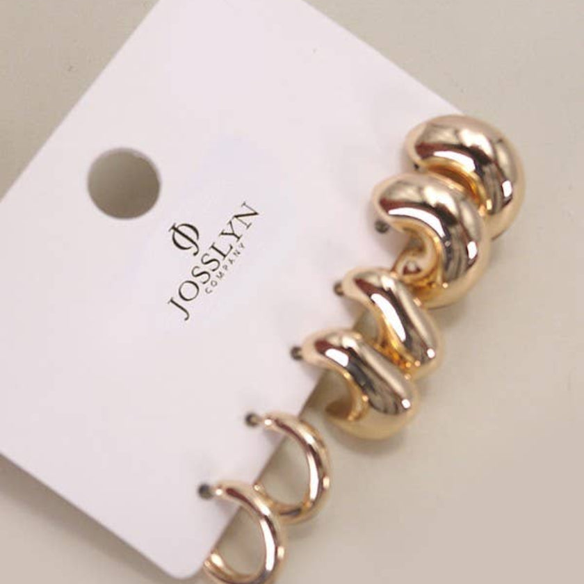 Gold spiral earrings on a Josievn branded card