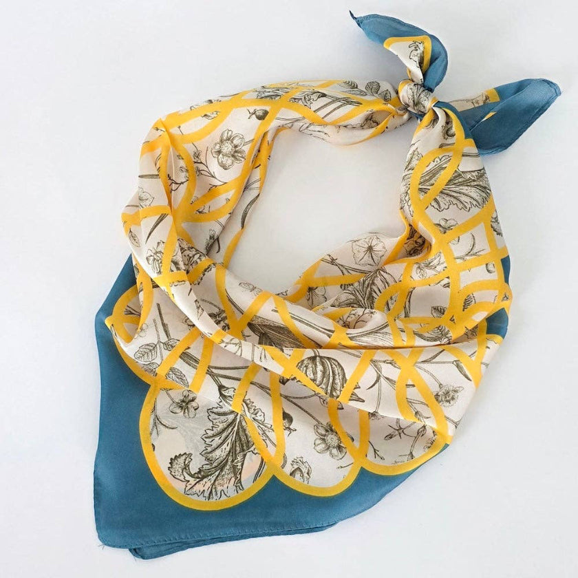 Floral patterned scarf with yellow accents on a white background