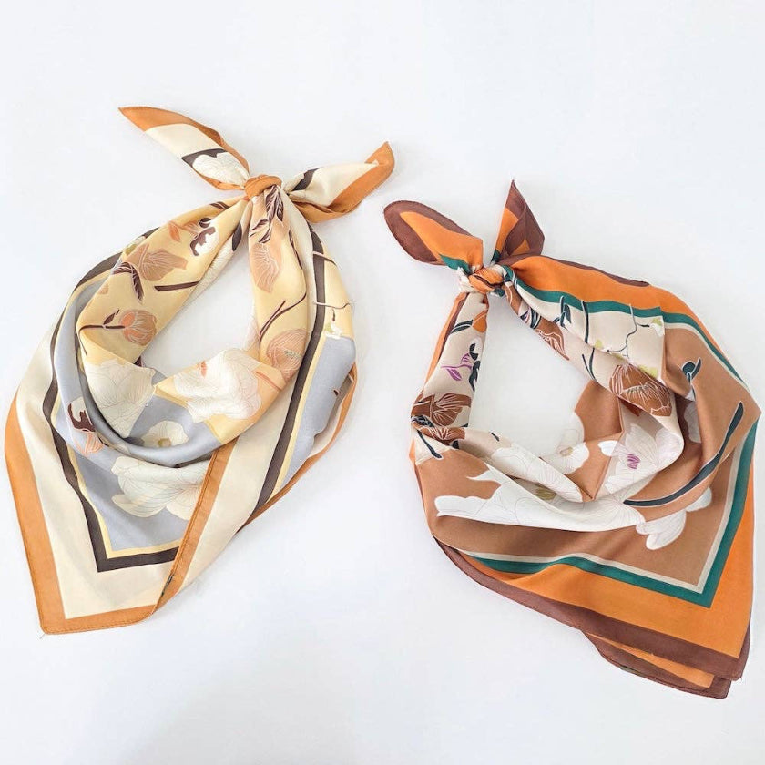 Two floral-patterned scarves on a white background