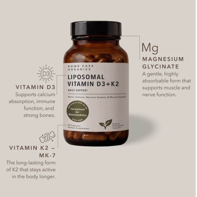 An amber supplement bottle labeled 'Liposomal Vitamin D3+K2' by Rowa Casa Organics, shown on a light beige background with callout text describing magnesium glycinate and vitamin D3 and K2 benefits.
