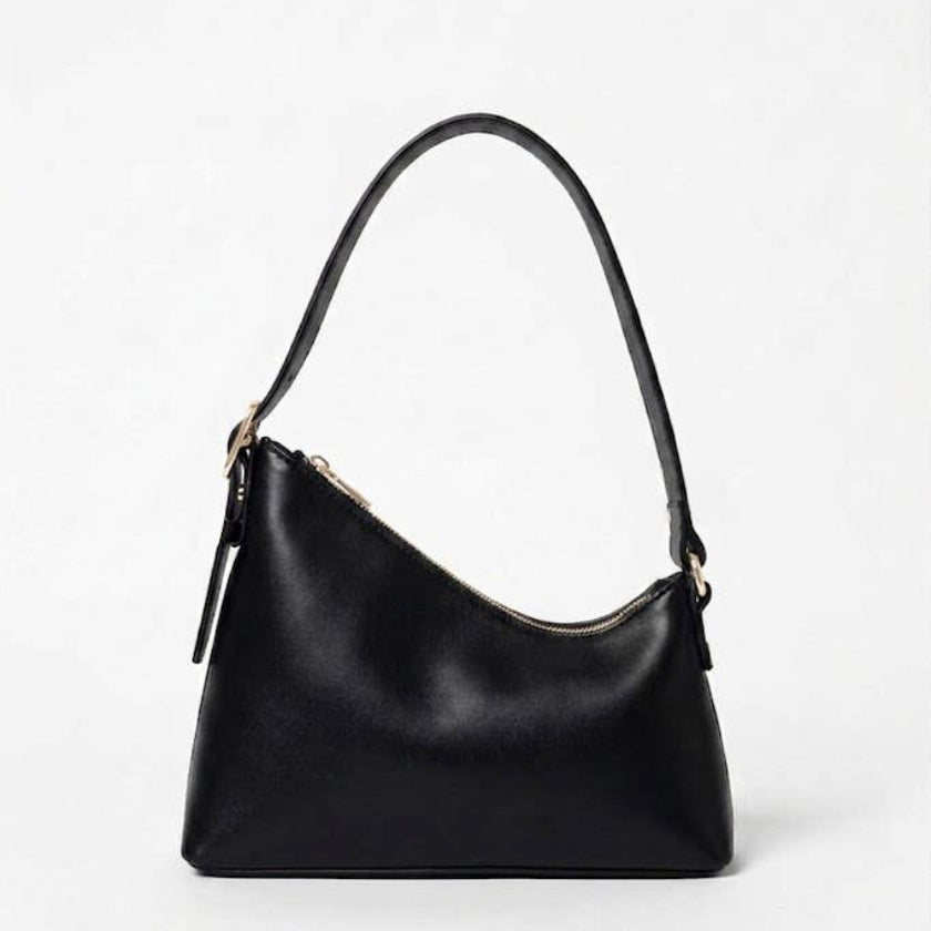 A black leather shoulder bag with a curved, slouchy silhouette, a single shoulder strap, and a top zipper closure, shown against a plain light gray background.