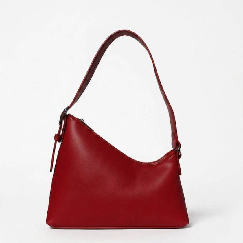 A red leather shoulder bag with a slouchy, slouchy hobo silhouette, a single shoulder strap, and a zippered top closure, shown on a plain white studio background.