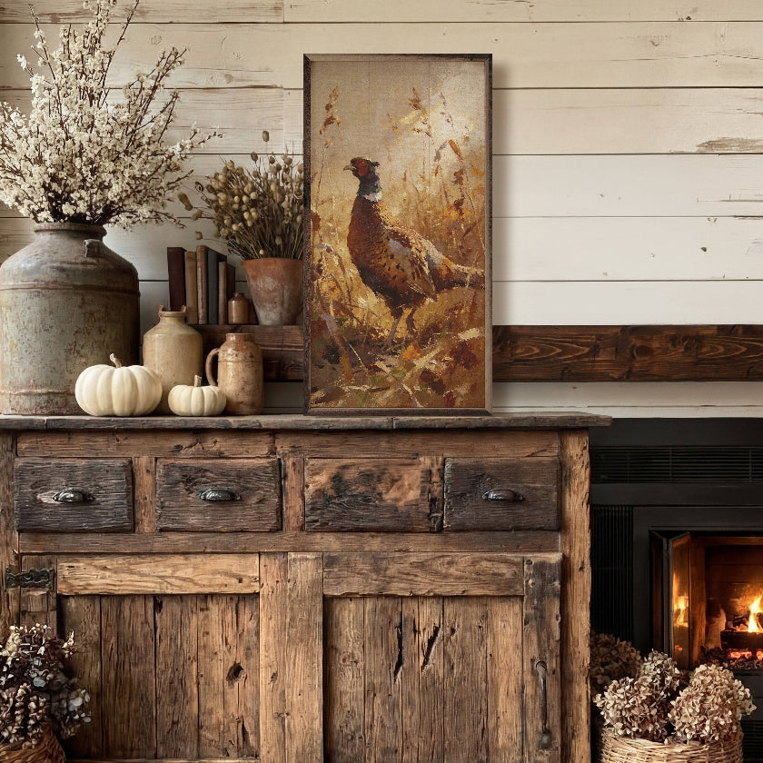 Rustic wooden cabinet with decorative items and a painting of a pheasant in a room with a fireplace.