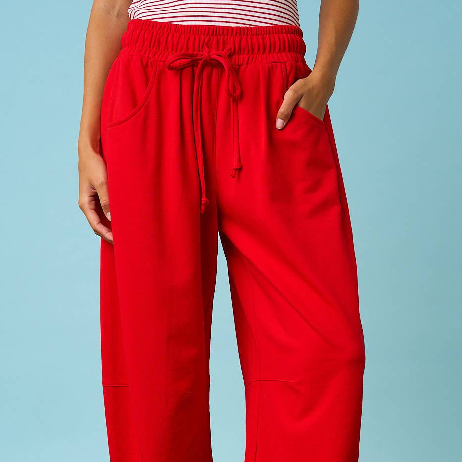 Person wearing red pants with a blue background