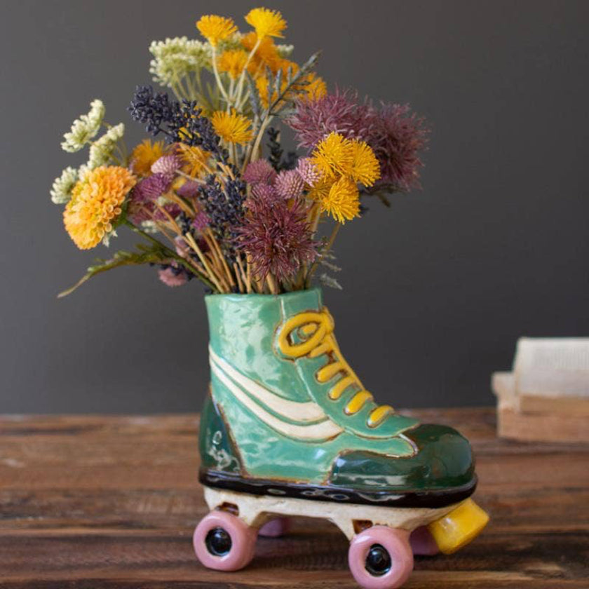 Roller skate vase with flowers on a wooden surface