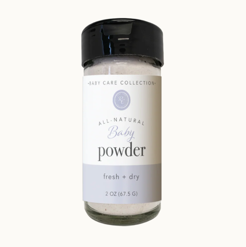 All-natural baby powder in a glass jar with a black lid on a white background