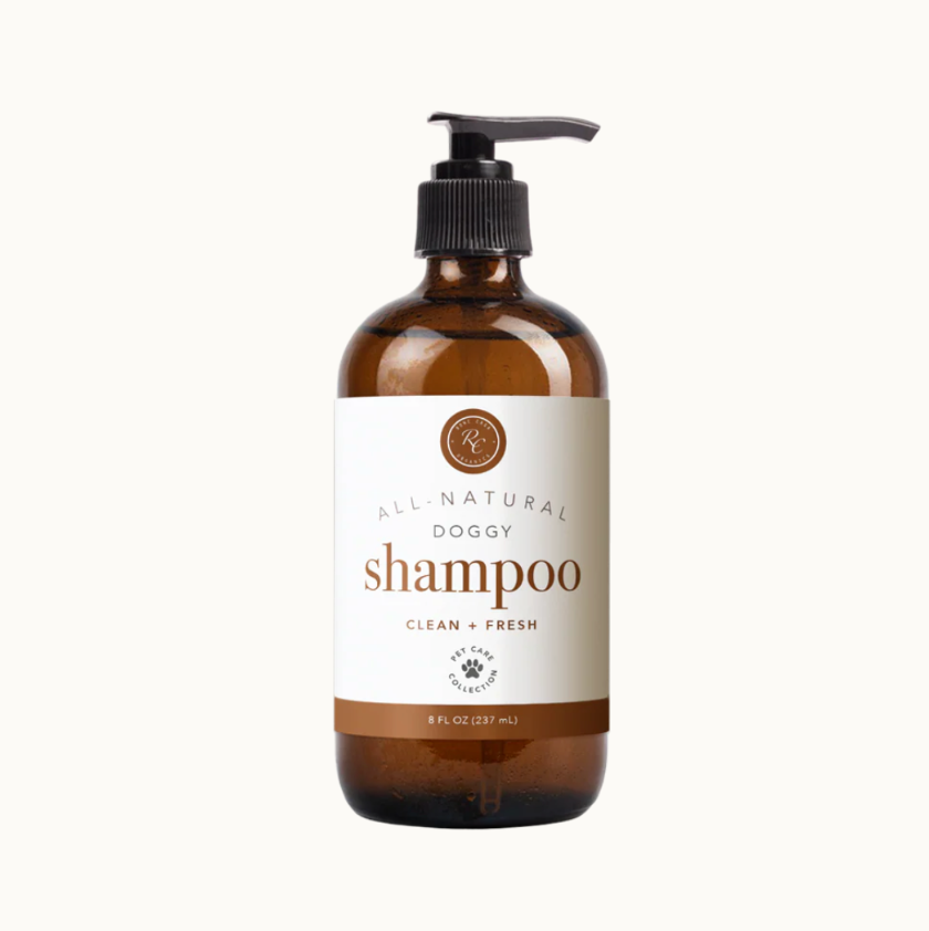 Brown bottle of all-natural dog shampoo with pump on a white background