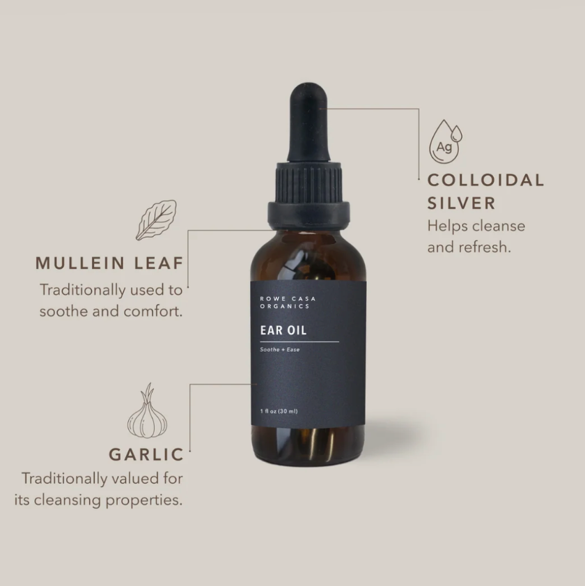 An amber glass dropper bottle of ear oil centered on a warm beige background, with callout lines and text describing ingredients: colloidal silver, mullein leaf, and garlic. The label reads 'Some Gave Organics' and 'Ear Oil'.