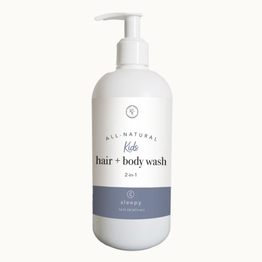 A white pump bottle labeled 'All Natural Kids hair + body wash 2-in-1 sleepy' with a blue lid.