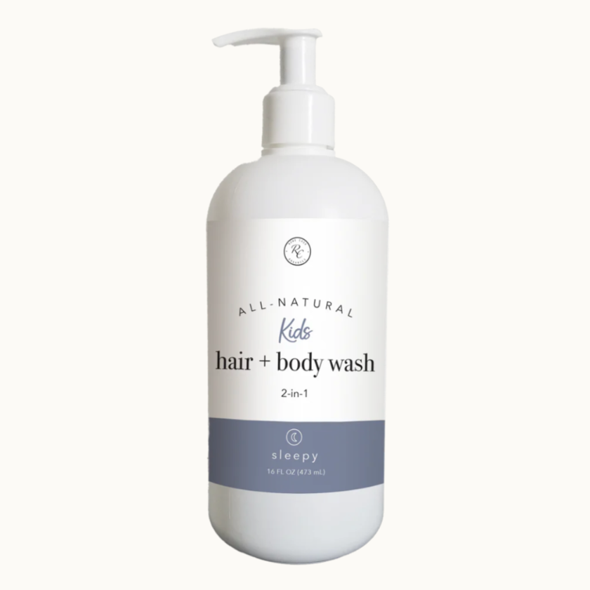 A white pump bottle labeled 'All Natural Kids hair + body wash 2-in-1 sleepy' with a blue lid.
