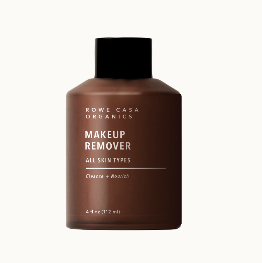 Brown bottle of makeup remover with black cap on a white background
