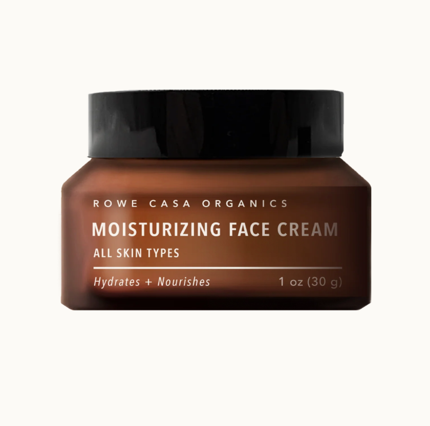 Brown jar of Rowe Casa Organics moisturizing face cream on a white background