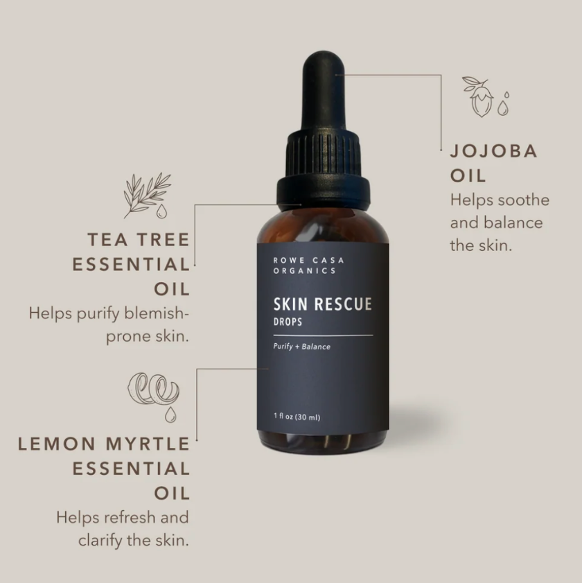 A bottle of Koni Casa Organics Skin Rescue Drops centered on a warm beige background, surrounded by callout lines and text describing tea tree essential oil, jojoba oil, and lemon myrtle essential oil benefits.