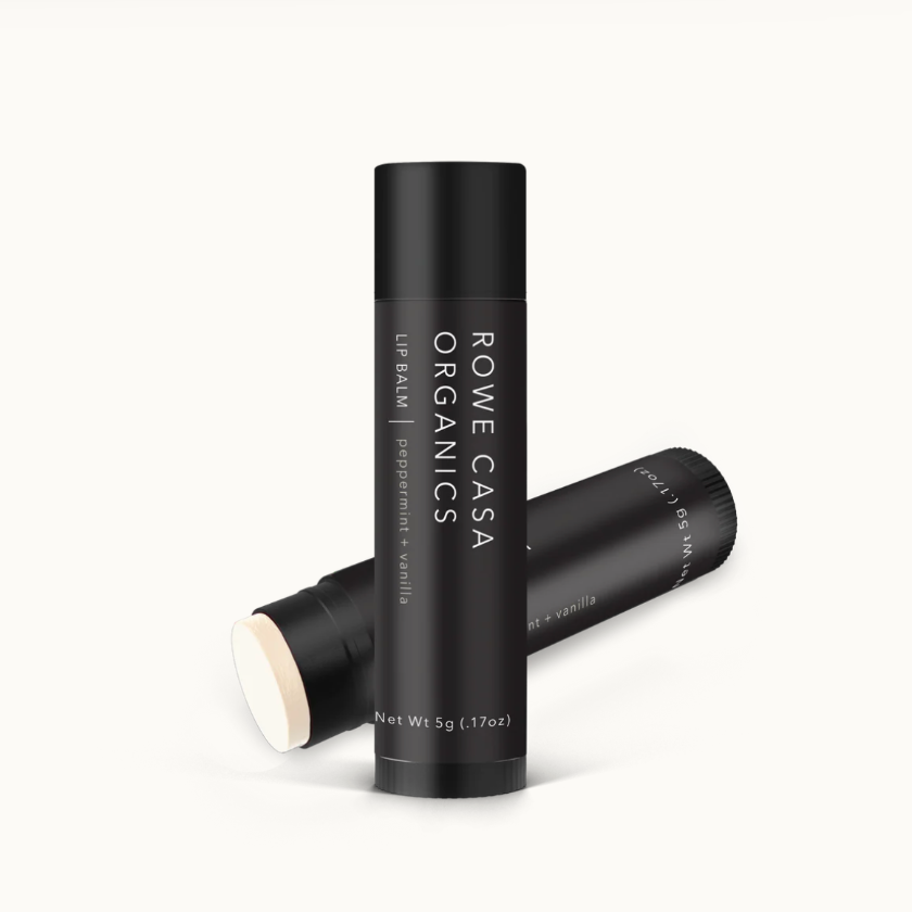 Two black lip balm tubes with 'Rome Casa Organics' branding on a white background