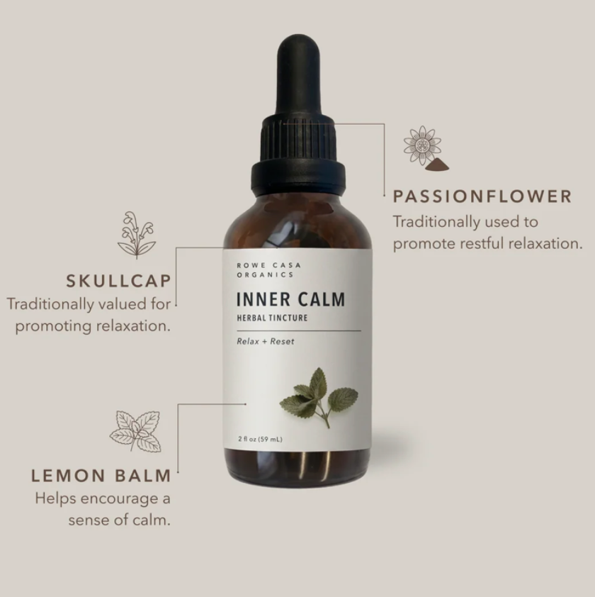 An amber glass dropper bottle labeled 'INNER CALM' by Rootava Organics, shown on a warm beige background with callout lines and text describing ingredients: passionflower, skullcap, and lemon balm.