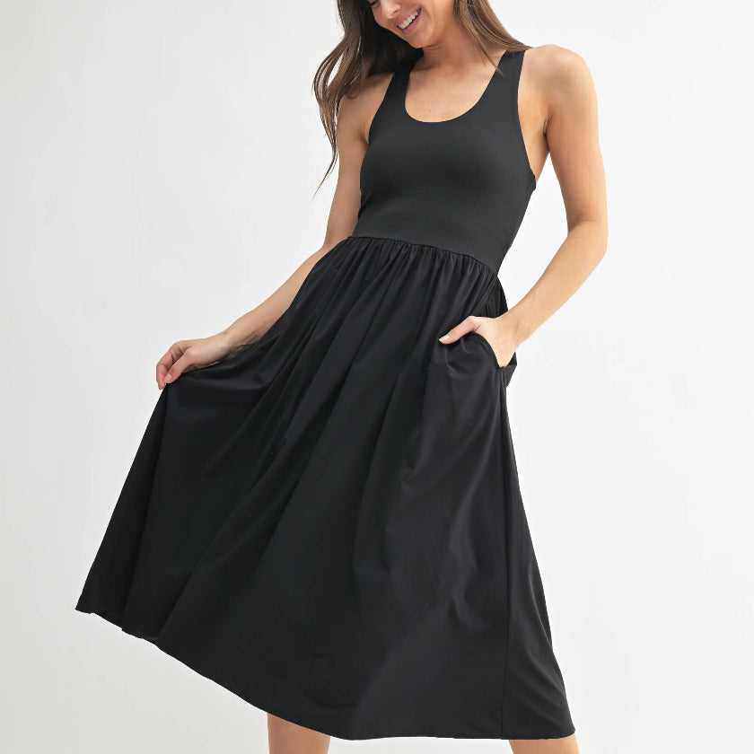 Woman wearing a black sleeveless dress on a white background