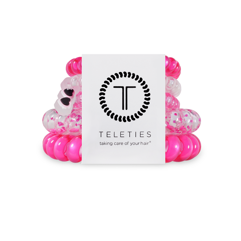 Pink and clear hair ties with a Teleties branded card on a white background