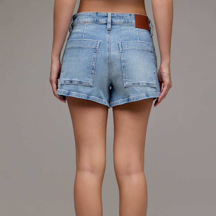 Person wearing light blue denim shorts on a plain background