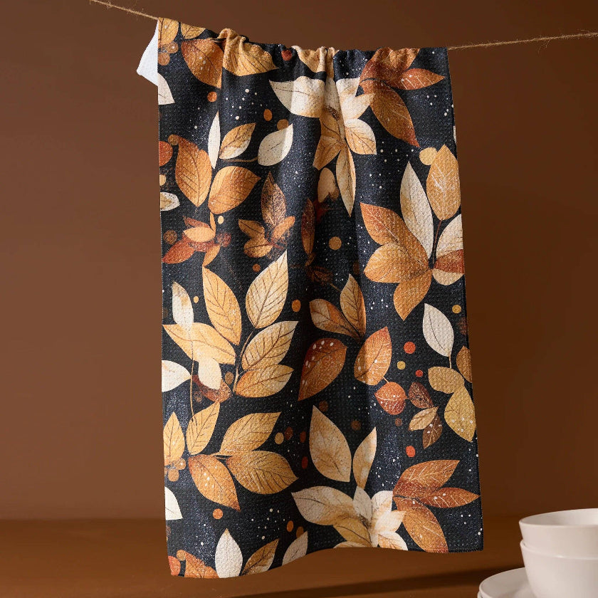 Towel with autumn leaf pattern on a brown background