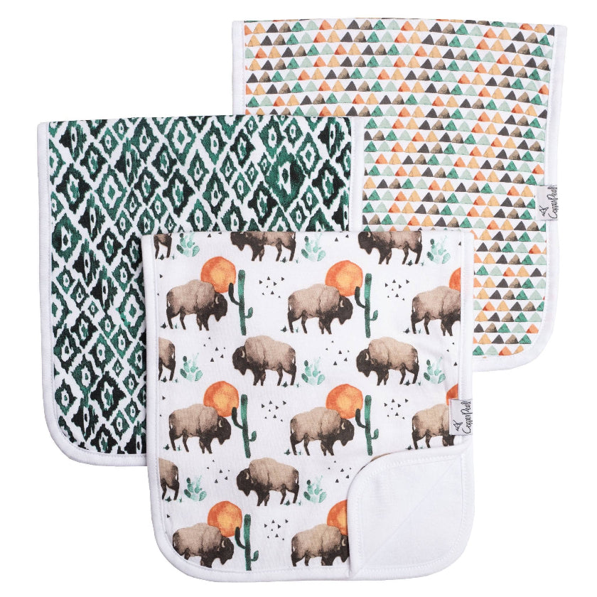 Set of four baby bibs with different patterns including geometric and animal designs.