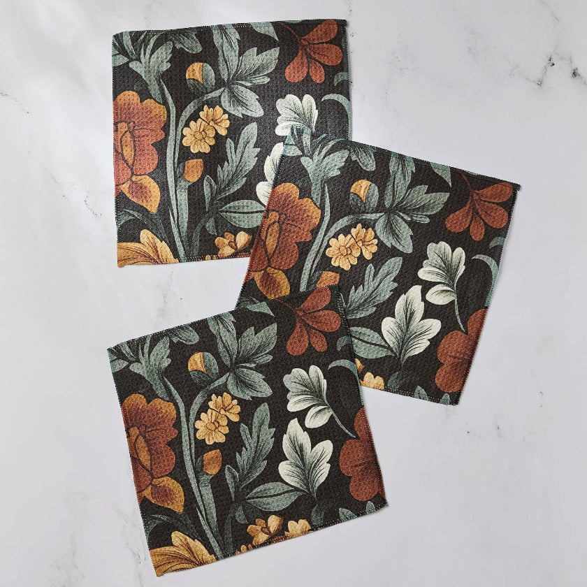 Two floral-patterned notebooks on a white marble surface
