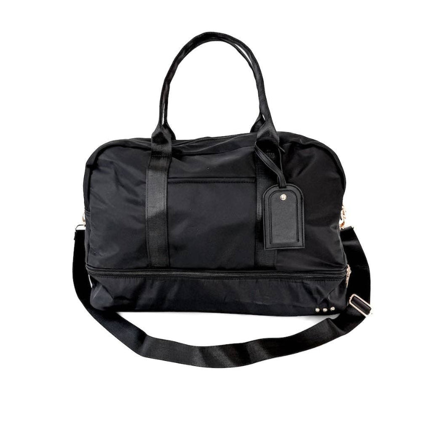 Black duffel bag with a shoulder strap on a white background