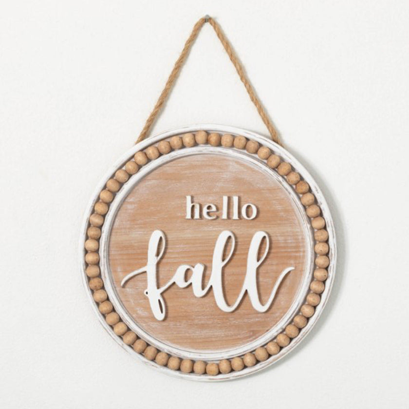 Hang this warm & welcoming medallion on the wall for a great way to usher in the harvest season. Measuring 11.75" around & suspended from a jute cord, this sign will greet everyone with a "hello fall" sentiment in its natural washed wood & bead border surround.
  
Dimensions:
12"L x1"W x12"